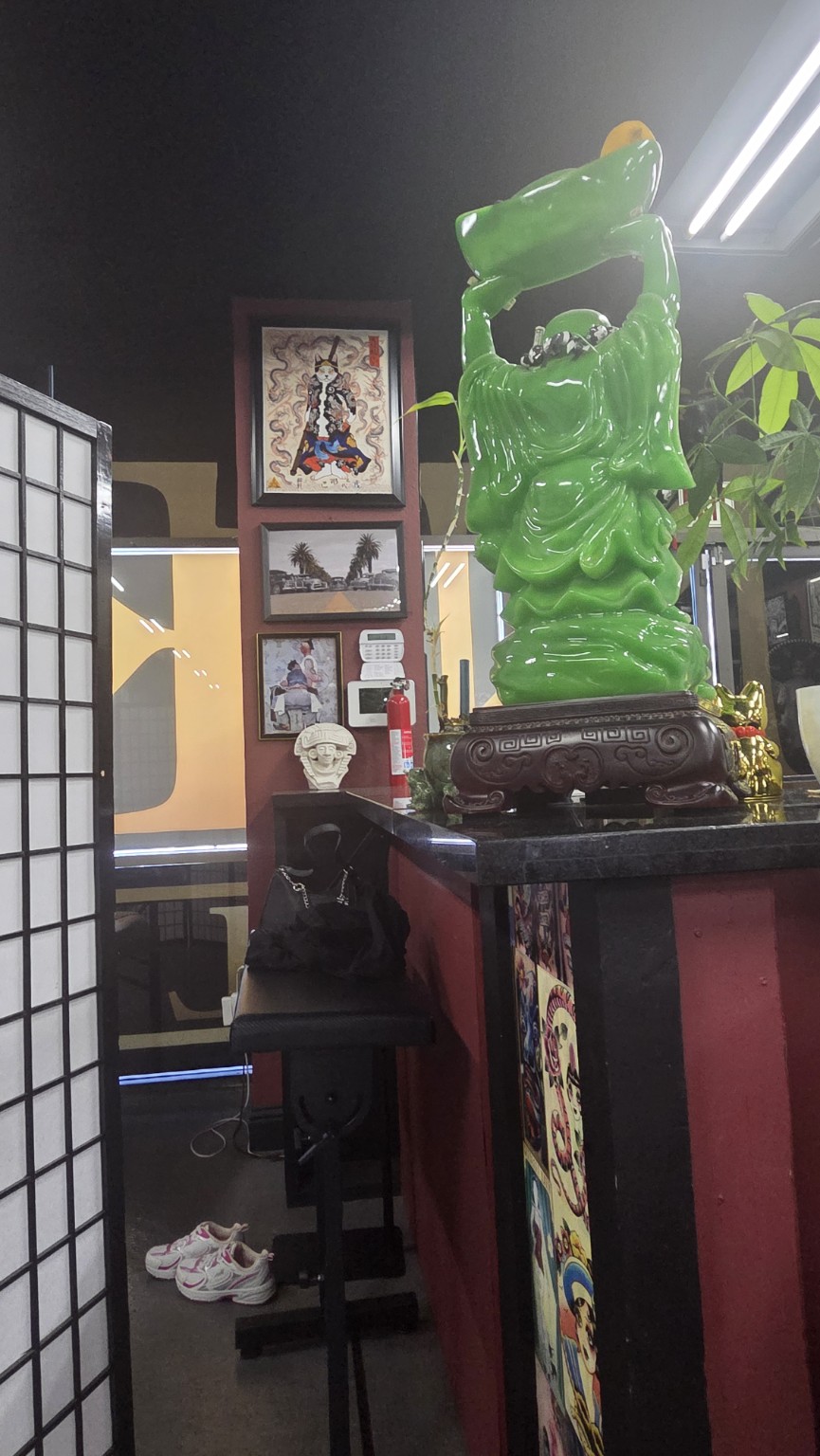 Ink Disciples studio interior and jade statue